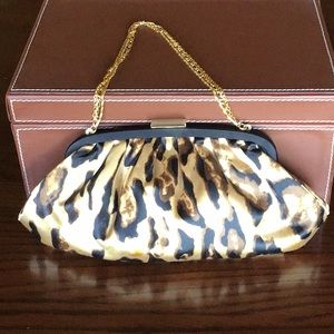 Satin leopard print clutch with gold clasp and chain.